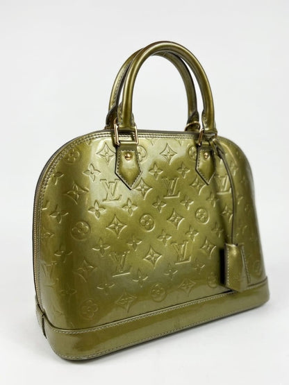 Vert Bronze Monogram Vernis Alma bag in a structured patent leathe